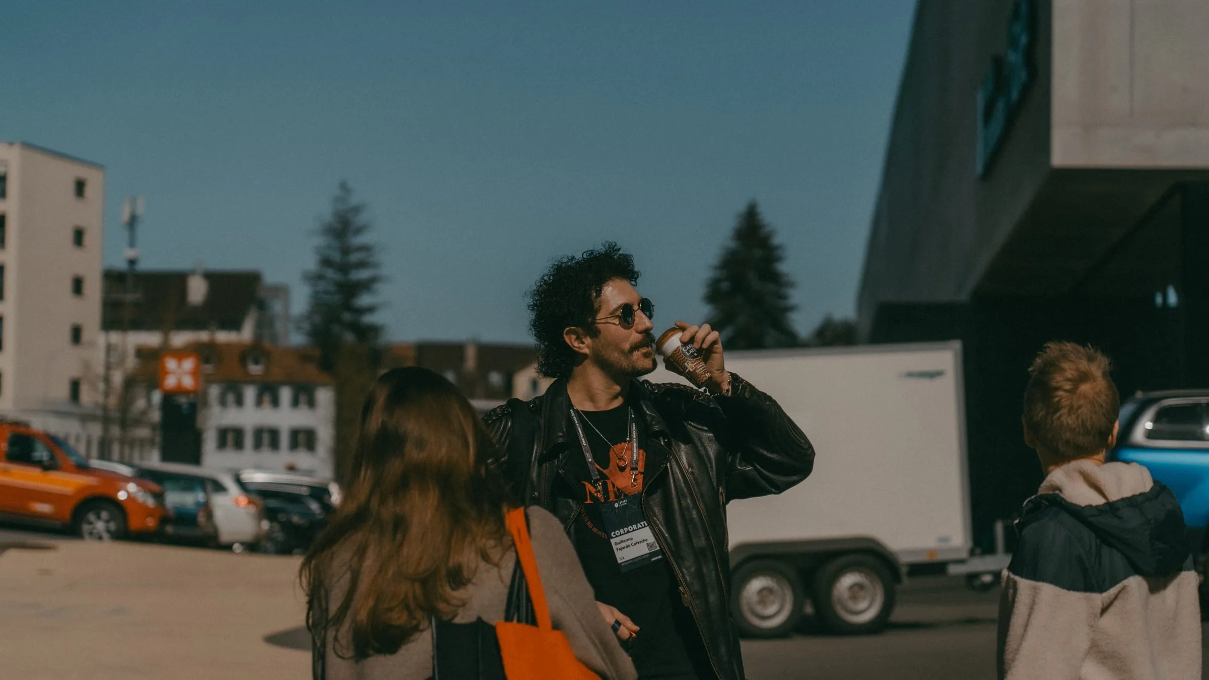 Teilnehmer mit Kaffee vor dem Eventgebäude